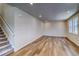 Bright and open living room with hardwood floors, a staircase, and multiple windows at 23951 E 40Th Ave, Aurora, CO 80019