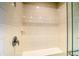 Glass enclosed shower featuring white subway tile, bench, and chrome faucet at 23951 E 40Th Ave, Aurora, CO 80019