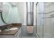 Bathroom with granite vanity, decorative mirror, and tiled shower at 564 S Grant St, Denver, CO 80209