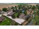 Aerial view showcasing a large house, detached garage, and pool at 14121 Countryhills Dr, Brighton, CO 80601