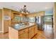 Spacious kitchen with island, stainless steel appliances, and hardwood floors at 14121 Countryhills Dr, Brighton, CO 80601