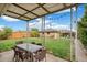 Covered patio with outdoor furniture, and a yard with green grass, a fence and a shed at 3620 Fairfax St, Denver, CO 80207