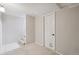 Carpeted room in the basement has neutral walls, and a door with a pet door at 3620 Fairfax St, Denver, CO 80207