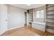 Sun-filled room with wood floors, built-in bookshelves and seating beneath a window at 3620 Fairfax St, Denver, CO 80207