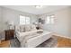 Bright bedroom features hardwood floors, neutral paint, and updated window treatments at 3620 Fairfax St, Denver, CO 80207