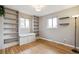 Sun-filled room with wood floors, built-in bookshelves and seating beneath a window at 3620 Fairfax St, Denver, CO 80207