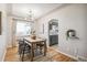 Bright dining room with wood table, modern chairs, hardwood floors, and an archway to the kitchen at 3620 Fairfax St, Denver, CO 80207