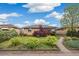 Charming brick home with well-maintained landscaping, including green bushes and a vibrant red tree at 3620 Fairfax St, Denver, CO 80207