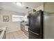 Well-lit kitchen features stainless appliances, updated cabinets, and tiled flooring at 3620 Fairfax St, Denver, CO 80207