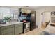 This kitchen features sage green cabinets, stainless appliances, and mosaic backsplash at 3620 Fairfax St, Denver, CO 80207