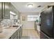 Bright kitchen features sage cabinets, stainless appliances, and tiled flooring at 3620 Fairfax St, Denver, CO 80207
