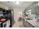 Kitchen view showcases stainless appliances, updated cabinets, and view into dining room at 3620 Fairfax St, Denver, CO 80207