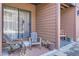 Cozy covered patio with chairs and sliding glass door at 540 S Forest St # 8-101, Denver, CO 80246