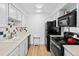 Updated kitchen features white cabinets, neutral countertops, and new appliances at 14206 E 1St Dr # B10, Aurora, CO 80011