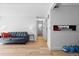 Living room featuring hardwood floors, neutral paint, and entry to bathroom down the hall at 14206 E 1St Dr # B10, Aurora, CO 80011