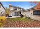 Backyard with patio, grill, firepit, and landscaped yard with mature trees in the autumn at 2218 S Clayton St, Denver, CO 80210