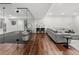 Finished basement with glass enclosed gym, wood flooring, a gray sofa and recessed lighting at 2218 S Clayton St, Denver, CO 80210