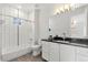 Modern bathroom featuring white subway tile, dark countertops, and a sleek vanity with updated fixtures at 2218 S Clayton St, Denver, CO 80210