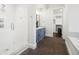 Well-appointed bathroom featuring a glass-enclosed shower, custom vanity, and stylish herringbone floors at 2218 S Clayton St, Denver, CO 80210