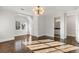 Sun-drenched bedroom with hardwood floors, a stylish light fixture and neutral paint at 2218 S Clayton St, Denver, CO 80210