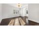 Bright bedroom features hardwood floors, modern light fixture and natural light from dual windows at 2218 S Clayton St, Denver, CO 80210