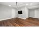 Bedroom features hardwood floors, recessed lights, and a mounted flatscreen TV at 2218 S Clayton St, Denver, CO 80210