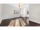 Light-filled bedroom with hardwood floors and a modern lighting fixture at 2218 S Clayton St, Denver, CO 80210