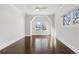 Sunlit bedroom with hardwood floors, a large window with neighborhood views, and crown molding at 2218 S Clayton St, Denver, CO 80210