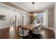 Bright dining room features modern lighting, large windows, and sleek, neutral-toned chairs at 2218 S Clayton St, Denver, CO 80210