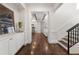 Inviting entryway with hardwood floors, white trim, and views into the living room at 2218 S Clayton St, Denver, CO 80210