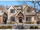 Charming two-story home with brick facade, dark window trim, front porch, and wrought iron fence at 2218 S Clayton St, Denver, CO 80210