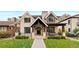 Beautiful two-story home boasting a manicured front yard, covered porch, and classic architectural details at 2218 S Clayton St, Denver, CO 80210