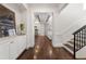 Inviting hallway featuring hardwood floors, elegant trim, and a seamless transition to living spaces at 2218 S Clayton St, Denver, CO 80210