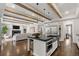 Open-concept kitchen with a large island, stainless steel appliances, and a connected living space at 2218 S Clayton St, Denver, CO 80210