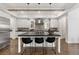 Elegant kitchen with a center island, stainless steel hood, and classic white cabinetry at 2218 S Clayton St, Denver, CO 80210