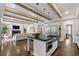 Modern kitchen with a large island, stainless steel appliances, and an open view of the living area at 2218 S Clayton St, Denver, CO 80210