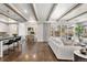 Inviting living area featuring a spacious layout, hardwood floors, and seamlessly connecting to the kitchen and dining area at 2218 S Clayton St, Denver, CO 80210