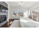 Serene main bedroom with a fireplace, hardwood floors, and a large window overlooking the neighborhood at 2218 S Clayton St, Denver, CO 80210