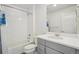 Bathroom features white subway tile shower and gray vanity at 5668 Galena St, Denver, CO 80238