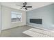 This bedroom has a modern ceiling fan, carpet flooring, and a large window with natural light at 5668 Galena St, Denver, CO 80238