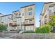 Modern townhome featuring a fenced yard, balcony, and contemporary architectural details at 5668 Galena St, Denver, CO 80238
