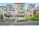 Contemporary townhomes with fenced yards, balconies, and modern architectural elements at 5668 Galena St, Denver, CO 80238
