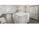 Open concept kitchen features island, stainless steel appliances, and gray cabinets at 5668 Galena St, Denver, CO 80238