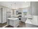 Bright kitchen features stainless steel appliances, gray cabinets and quartz countertops at 5668 Galena St, Denver, CO 80238