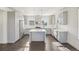 Modern kitchen featuring gray cabinets, stainless steel appliances, and a center island at 5668 Galena St, Denver, CO 80238