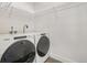 Clean laundry room features new front load washer and dryer and wire shelving at 5668 Galena St, Denver, CO 80238