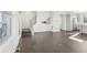 Open-concept living room featuring hardwood floors, white walls, and modern staircase at 5668 Galena St, Denver, CO 80238