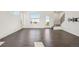 Spacious living room with large windows, modern staircase, and dark hardwood flooring at 5668 Galena St, Denver, CO 80238
