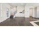 Bright living room with wood floors, staircase, and mounted TV bracket at 5668 Galena St, Denver, CO 80238