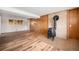 Finished basement with wood-look vinyl plank flooring, brick feature wall, and a wood-burning stove at 1529 Ashcroft Dr, Longmont, CO 80501